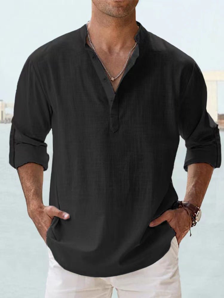 Men's black long sleeve henley shirt with rolled cuffs, casual style, paired with white pants