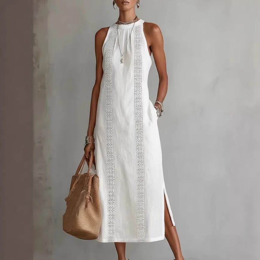 White sleeveless midi dress with lace trim, side slit, and pocket, paired with straw tote bag